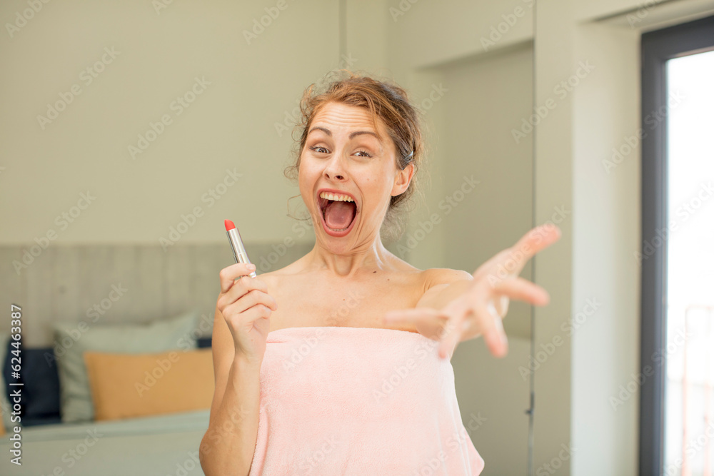 young pretty woman smiling happily and offering or showing a concept. lipstick concept young pretty woman smiling happily and offering or showing a concept. lipstick concept