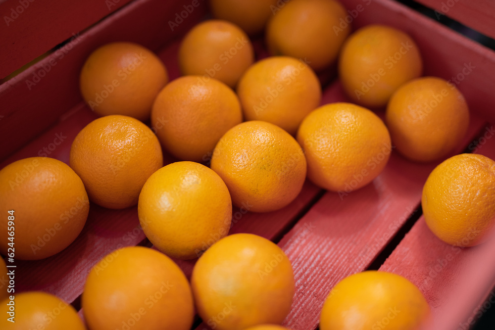 Many beautiful fresh oranges in a pink box