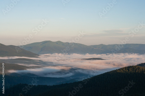 Fototapeta Naklejka Na Ścianę i Meble -  landscape sky clouds low in the mountains the sun rises, fog, above the clouds, wallpaper, poster, cover, the nature of the Carpathian mountains, green, natural beauty, vacation, outdoor