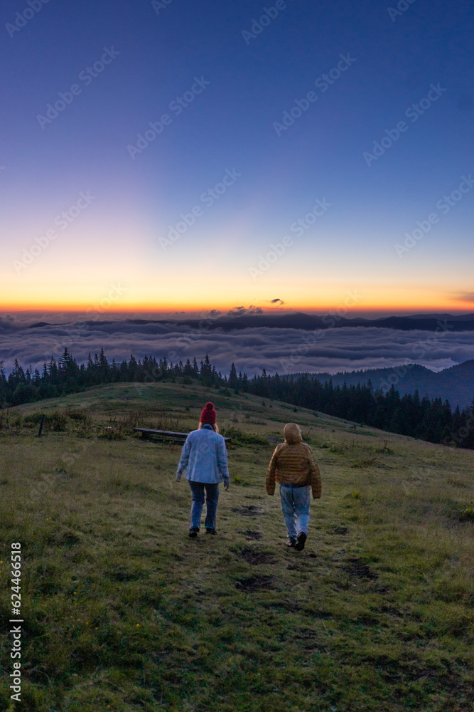 landscape in the mountains, sunset, sunrise, two friends looks at the horizon, walk, friendship, relationship, conquering the peaks, tourist, hiking, silhouettes of peaks, Montenegrin mountain range