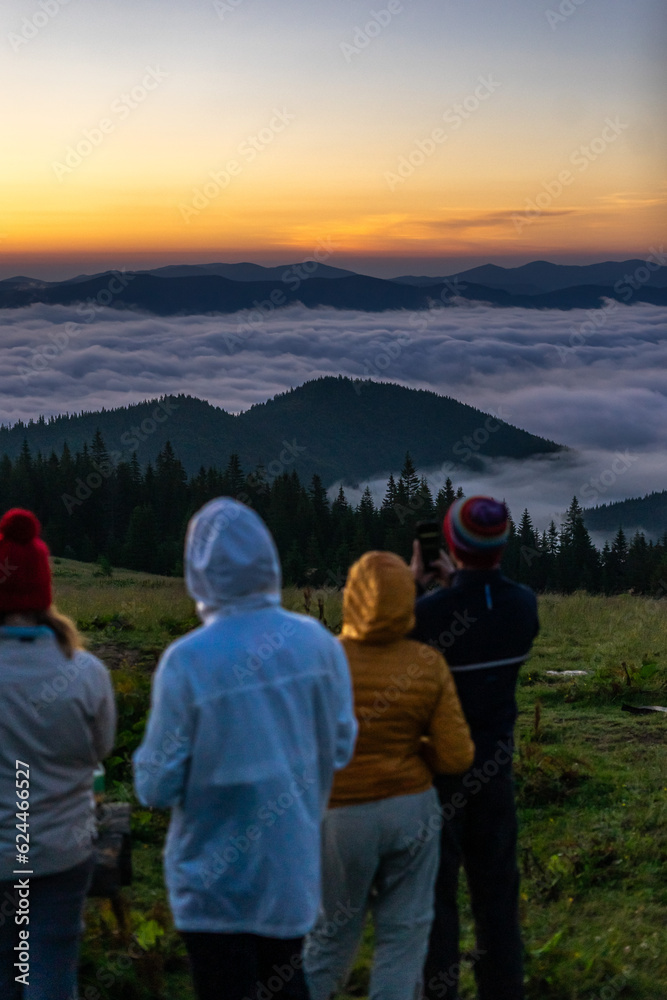 landscape in the mountains, sunset, sunrise, a company of friends looks at the horizon, conquering the peaks, tourist, hiking, silhouettes of peaks, Montenegrin mountain range, Carpathians, travel