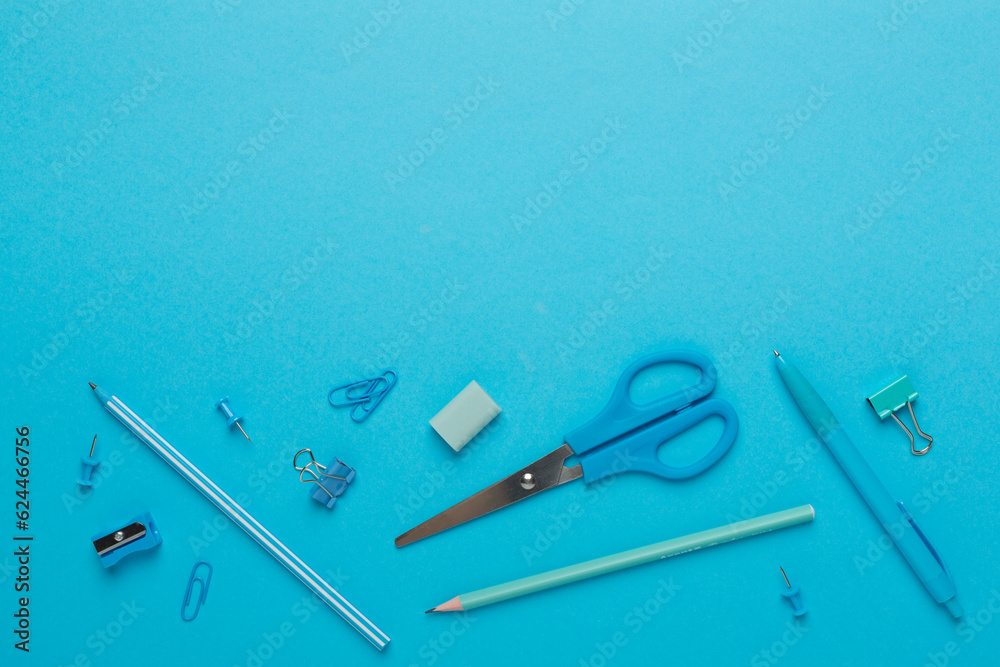 Flat lay with blue school stationery on color backgroung, top view Flat lay with blue school stationery on color backgroung, top view
