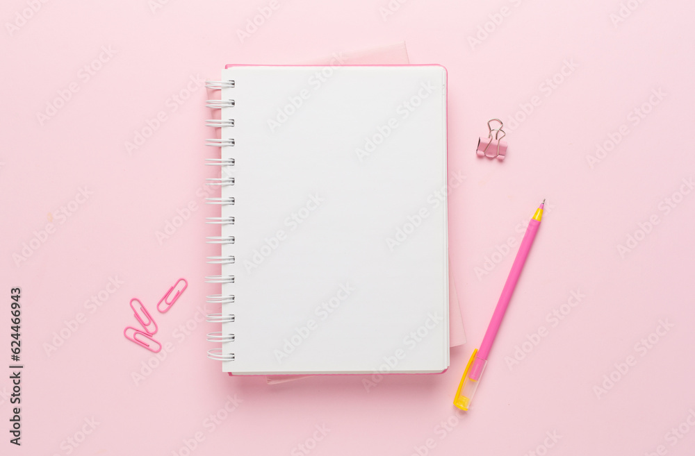 Notebooks with pen on color background, top view Notebooks with pen on color background, top view