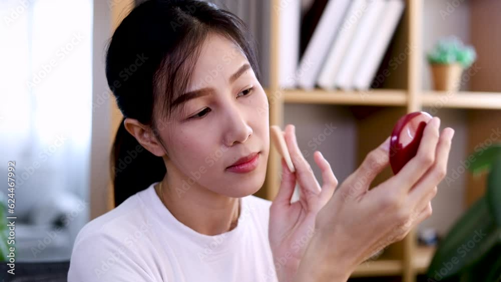 Young Asian blogger woman makeup using cosmetics in front of camera showing products quality for followers, daily lifestyle beautiful working woman before leaving the house or meeting with colleagues Young Asian blogger woman makeup using cosmetics in front of camera showing products quality for followers, daily lifestyle beautiful working woman before leaving the house or meeting with colleagues