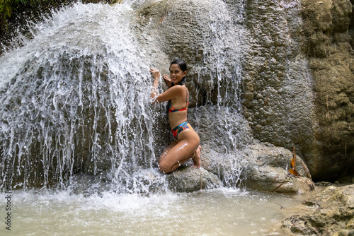 girl posing in a waterfall