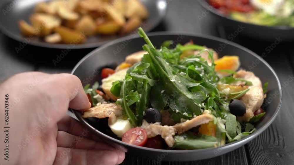 Served salad with grilled chicken breast and fresh vegetables in bowl on wooden table. Healthy lunch menu. Served salad with grilled chicken breast and fresh vegetables in bowl on wooden table. Healthy lunch menu.