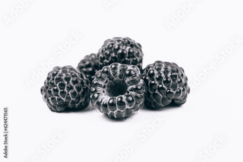 Macro shoot of sweet black raspberries on white background.