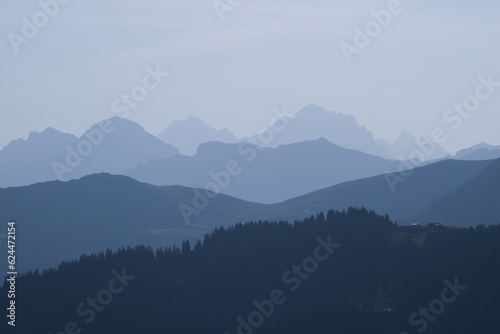 Blue mountain ranges in the morning light seen from Vorder Walig, Switzerland.