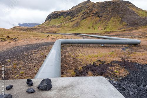 geothermal energy pipelines running along the desert hills of iceland photo