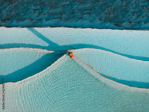 Woman in Red Dress on the Turquoise Travertines Drone Photo, Pamukkale Travertines Denizli, Turkey (Turkiye) photo