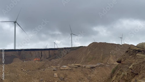 close up Drone Aerial view of wind turbine windmills turning with the wind in halifax UK, Withens. wind turbine farm  ovenden moor. with blue sky, with quarry photo