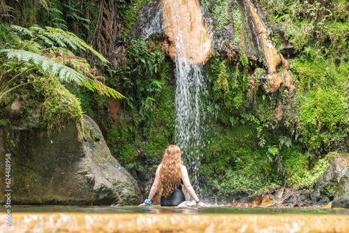 Woman in the hot springs of Caldeira Velha in Sao Miguel island of the Azores.