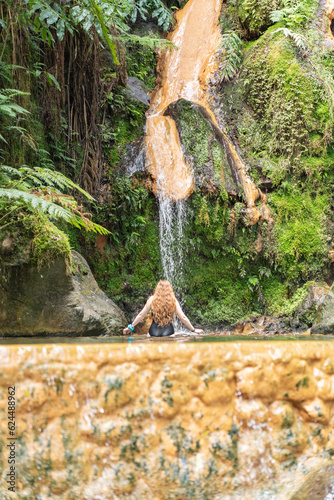 Woman in the hot springs of Caldeira Velha in Sao Miguel island of the Azores.