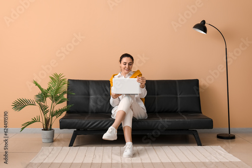 Young woman using laptop on...