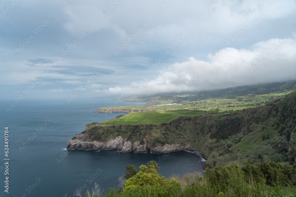 coastal view of the green hilly cliffs in the azores portugal