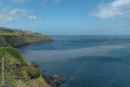 Landscape in Sao Miguel island with volcanic rocks touching the sea. 