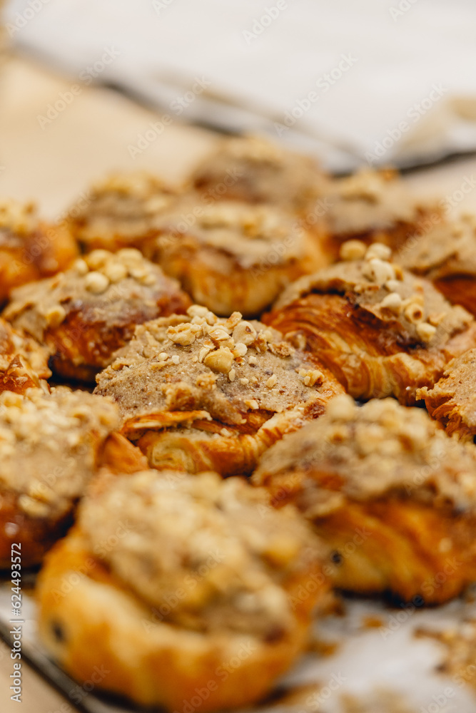 delicious fresh golden nutty pastries on baker's tray ready to be sold delicious fresh golden nutty pastries on baker's tray ready to be sold