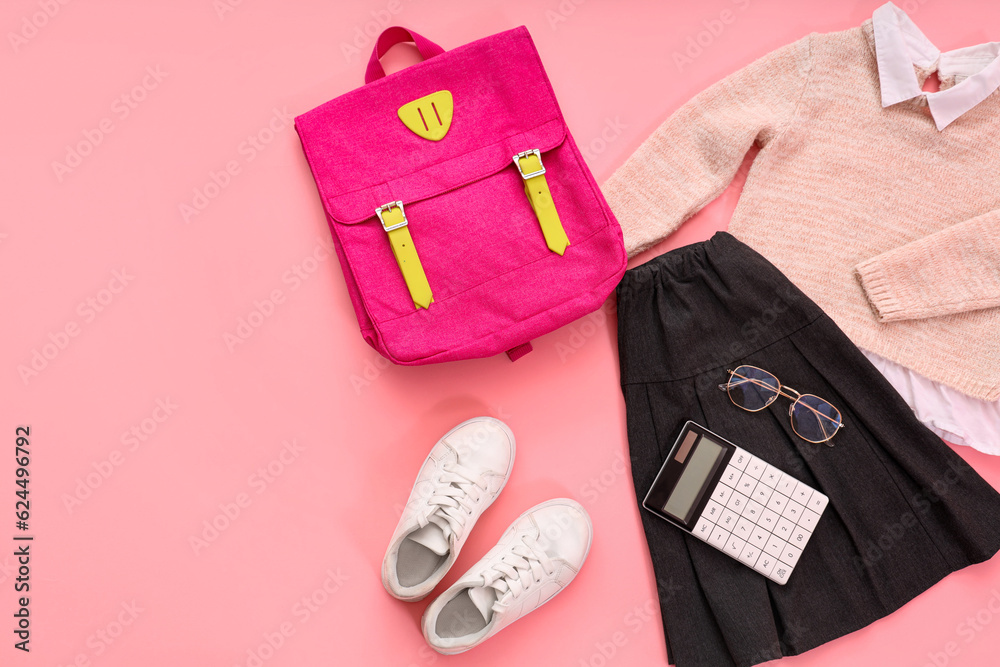 Composition with stylish school uniform, backpack, eyeglasses and stationery on pink background Composition with stylish school uniform, backpack, eyeglasses and stationery on pink background