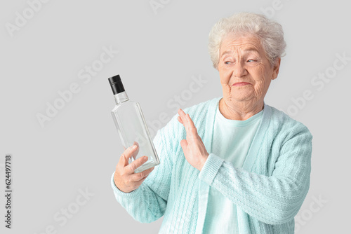 Senior woman rejecting bott...