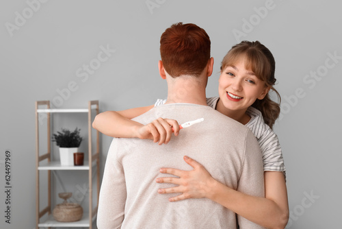 Happy young woman hugging p...