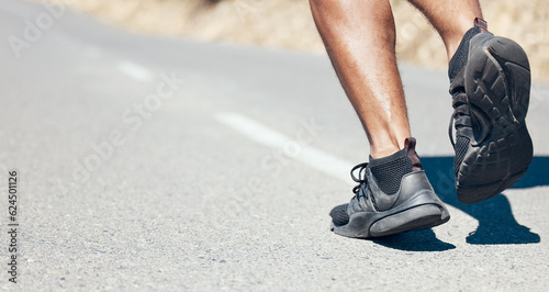 Man, fitness and running shoes on road for exercise, cardio workout or training on asphalt outdoors. Feet of fit, active or sporty male person, athlete or runner exercising or run on mountain street
