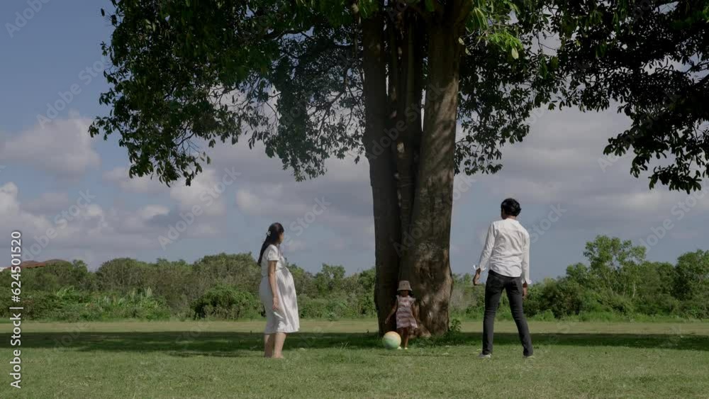 Young family playing ball in the park Young family playing ball in the park