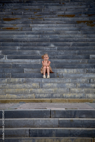Portrait of a girl sitting on concrete steps
