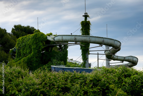 old abandoned overgrown lost place water slide