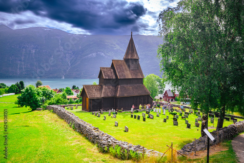 Fototapeta Naklejka Na Ścianę i Meble -  Ornes, Norway - July 4th, 2023: The Urnes stave Church in the village of Ornes. A UNESCO world heritage site