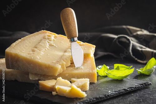 Tasty parmesan cheese on cutting board.