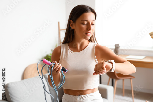 Young woman checking fitnes...