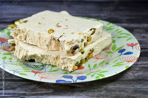 Traditional tahini halva with pistachios or Halawa Tahiniya, the primary ingredients in this confection are sesame butter or paste (tahini) sugar, glucose or honey, it is basic tahini and sugar base photo