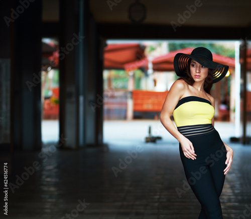 model in black pants yellow shirt