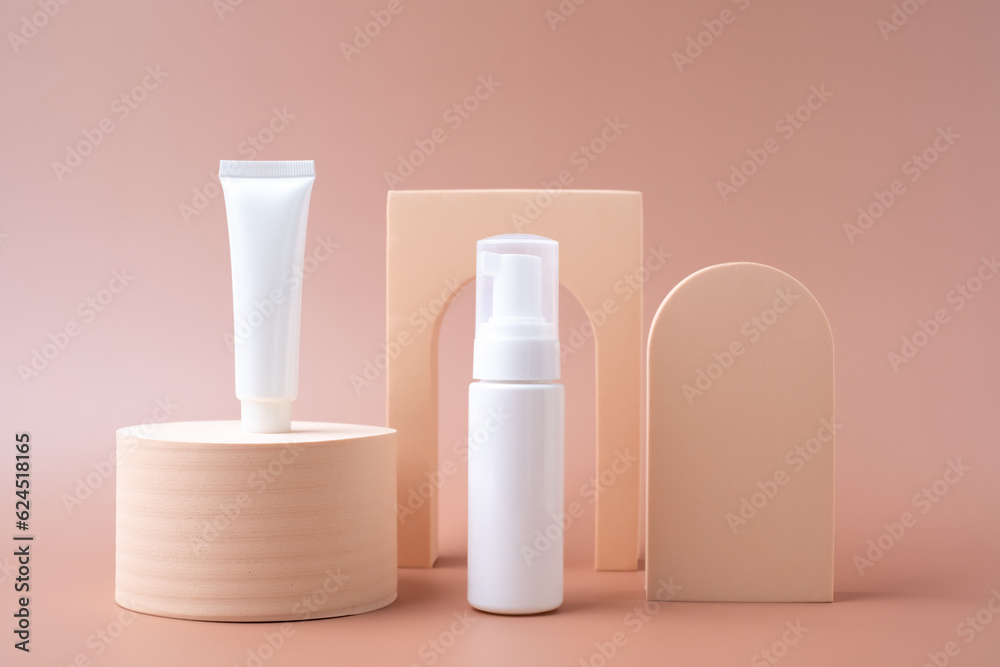 Mock-up pump, bottle, and tube for cosmetic and skin care products on a pastel background with minimal object design. Mock-up pump, bottle, and tube for cosmetic and skin care products on a pastel background with minimal object design.