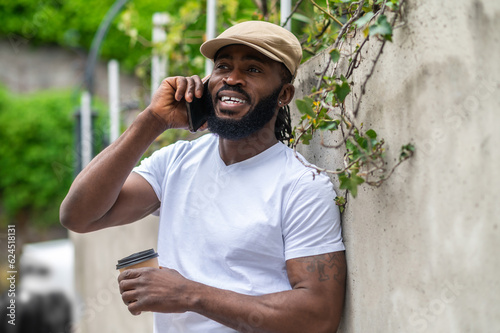 Smiling man talking on the phone and looking contented