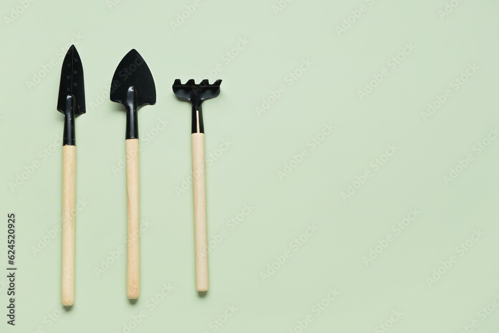 Gardening rake and shovels on green background Gardening rake and shovels on green background