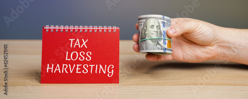 Notes with the Tax loss harvesting. Timely selling of securities at a loss to offset the amount of capital gains tax owed from selling profitable assets. Business and finance concept