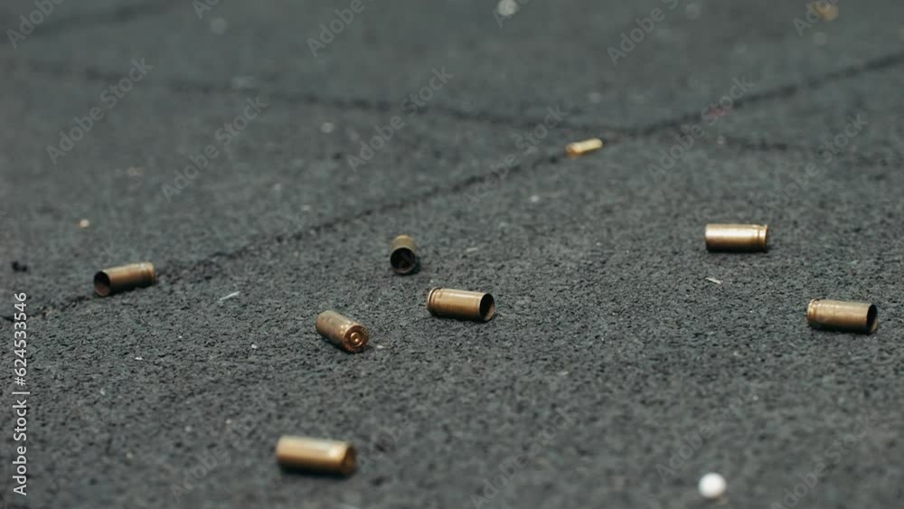 Empty bullets fall on the floor on shooting range. Sport shooter police training.