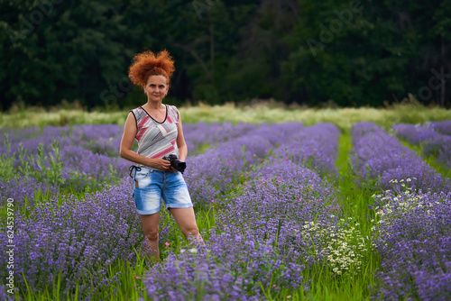 Fototapeta Naklejka Na Ścianę i Meble -  Nature photographer lady in a lavender field