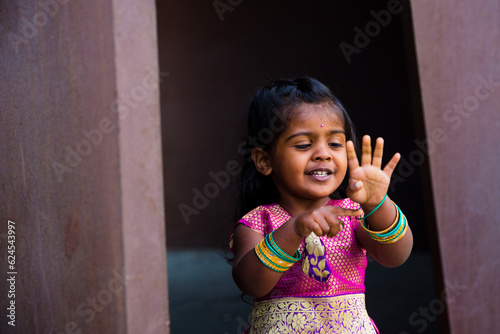 Photography close up of little indian girl wearing a sari and bindi and traditional bracelet