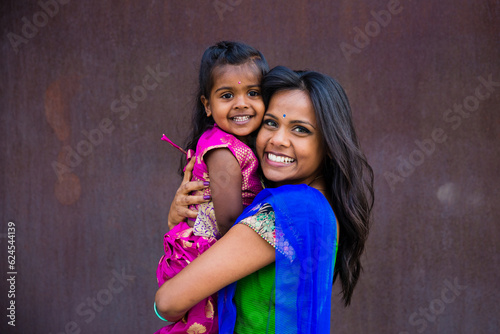 Photography beautiful indian family mom mother with daughter girl hugging and smiling with a