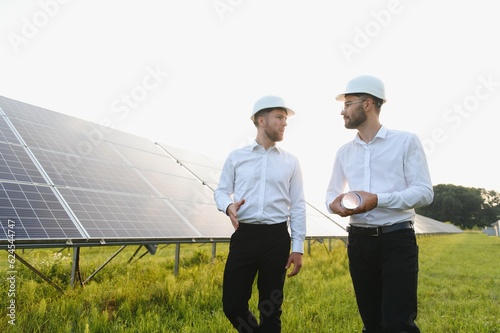 engineer and businessman planing new ecology project. around solar panel. © Serhii