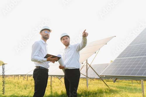 Project manager discuss with worker installation process of solar panel