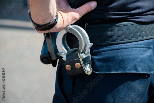 Police officer, policeman with handcluffs on belt, clime prevention