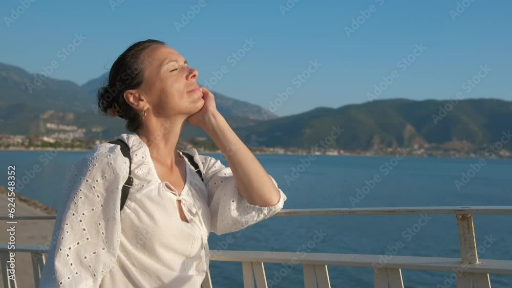 Woman with closed eyes on the background of the sea landscape. Woman with closed eyes on the background of the sea landscape.