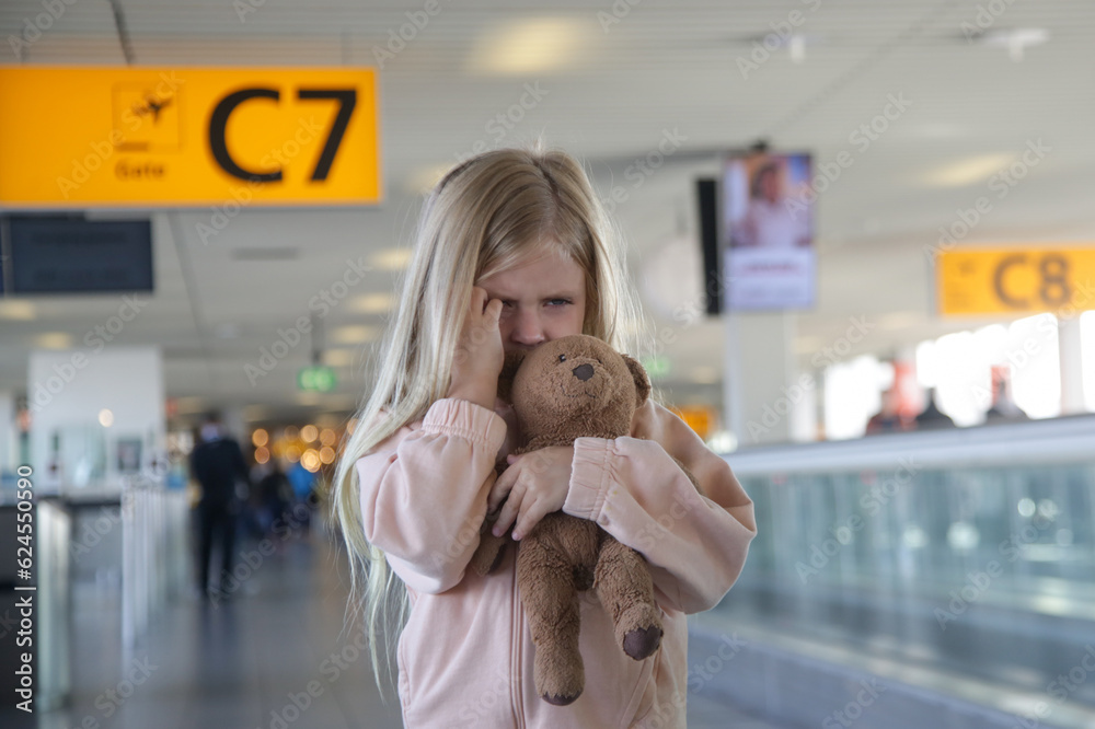Child lost at the airport, can't find her parents. Upset little girl