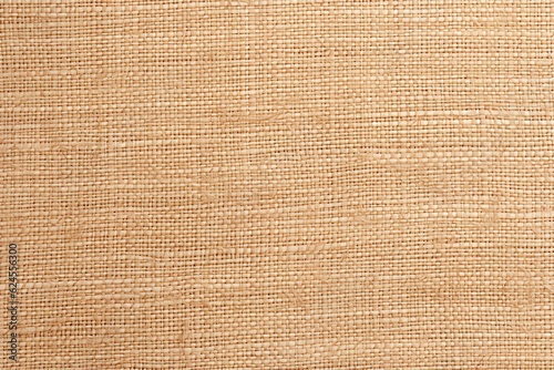 Jute hessian sackcloth canvas woven texture pattern background in light beige cream brown color blank empty