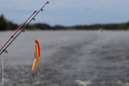 Jointed fishing lure dangling over water