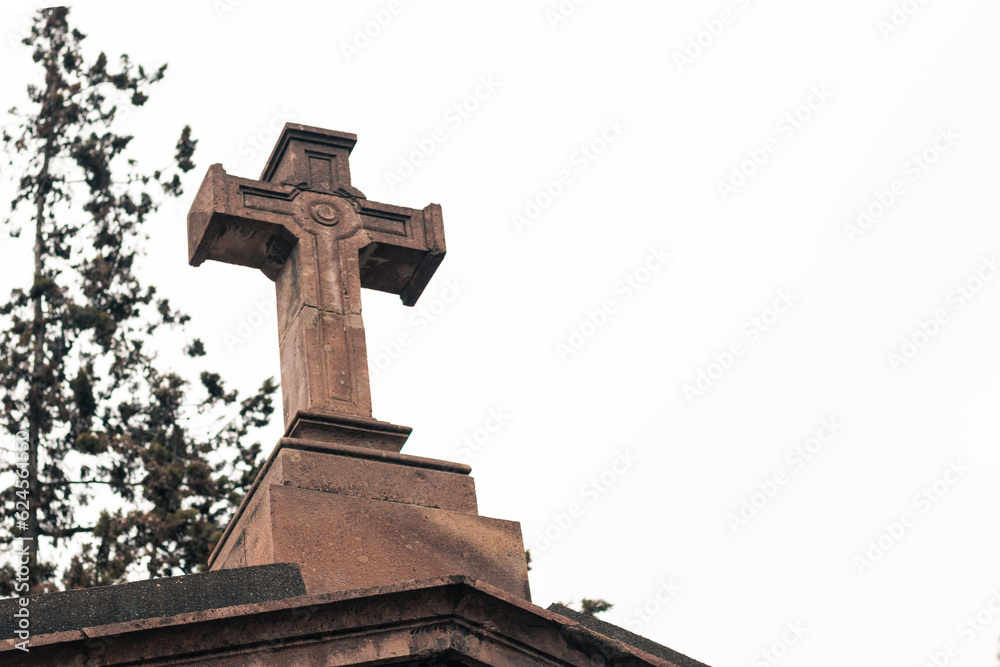 ancient christian cross on a temple grave in an outdoor cemetery. ancient christian cross on a temple grave in an outdoor cemetery.