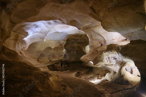 BURNET, TEXASUSA - JULY 3rd 2023: a family with a teenage girl on a road trip during school summer holidays, visiting Longhorn Cavern State Park with its intricate paths and natural stone works. photo